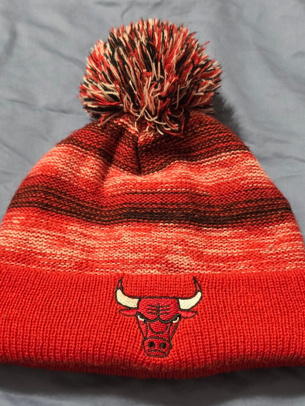 Stay warm and rep your team with this cozy Chicago Bulls pom-pom beanie!